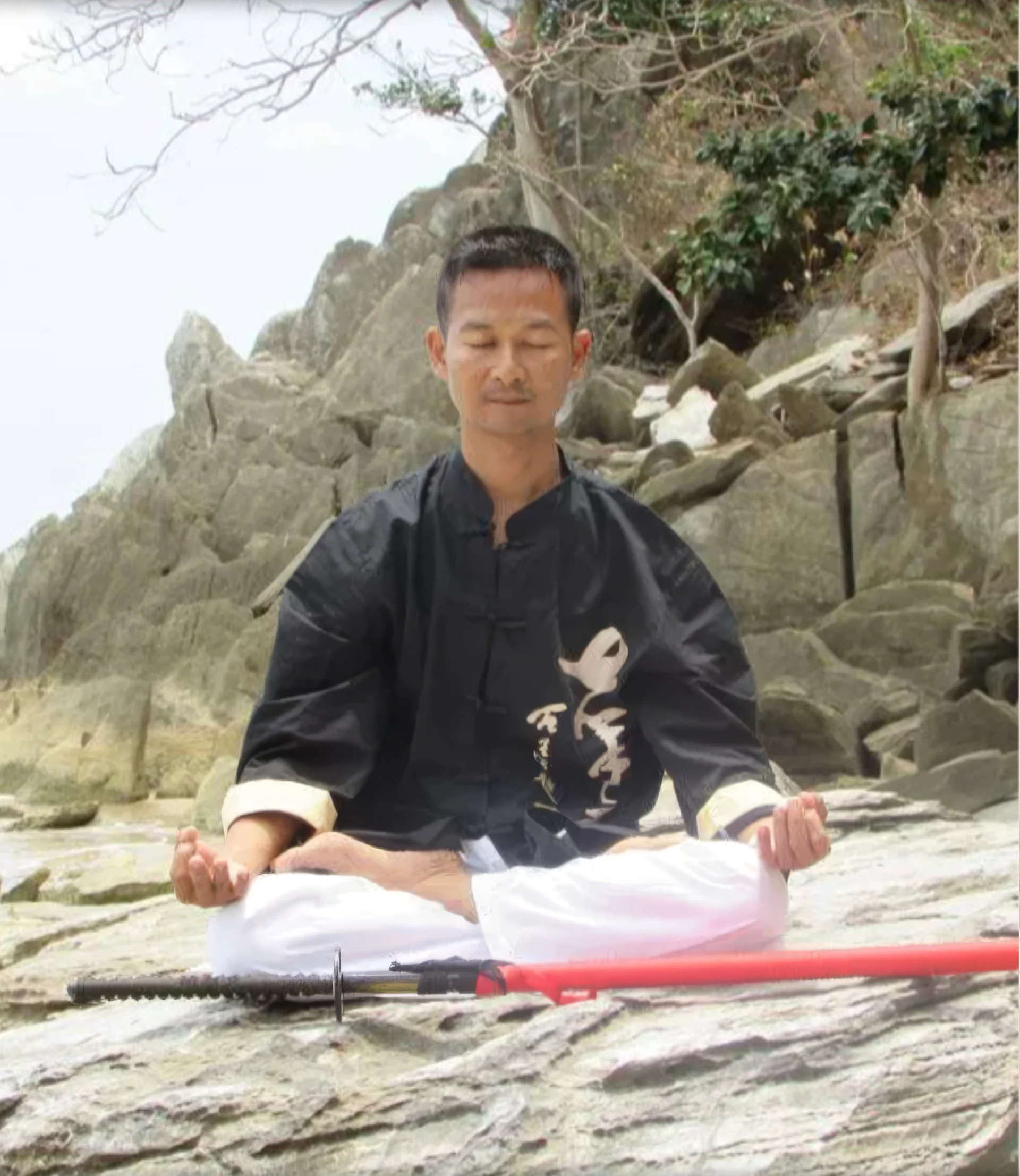 Reiki Master Jet Lee meditating on the beach